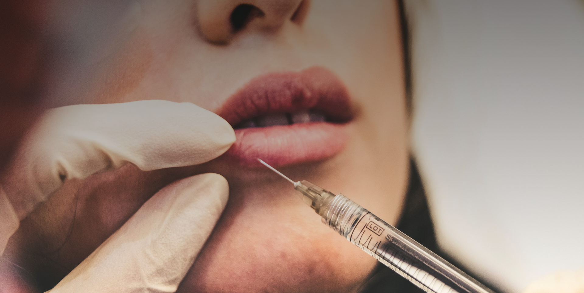 close up of needle injecting lip fillers